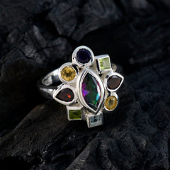 Mathilde multicolor navratna ring featuring a central marquise gemstone surrounded by various colorful stones in silver setting