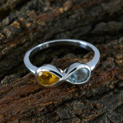 Jia silver multicolor toi et moi ring with yellow and light blue gemstones on rustic wood