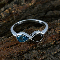Victoria silver multicolor toi et moi ring with blue and black gemstones on textured bark background