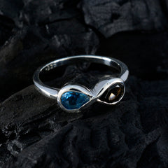 Victoria silver multicolor toi et moi ring with blue and brown gemstones on black textured background