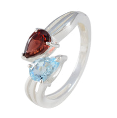 Freya multicolor toi et moi ring with pear shaped red garnet and blue topaz gemstones on silver band