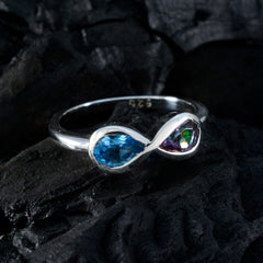 Jiwoo sterling silver multicolor toi et moi ring with blue pear gemstone and iridescent stone on black background