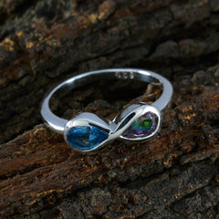 Jiwoo silver ring with pear shaped blue and iridescent stones on bark background multicolor toi et moi ring