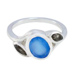 Ellie multicolor trilogy gemstone ring with a large blue center stone and two smaller dark stones on silver band