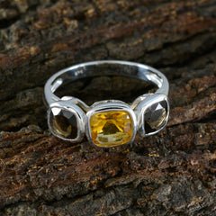 Isabelle silver multicolor trilogy gemstone ring with yellow and dark gemstones on tree bark