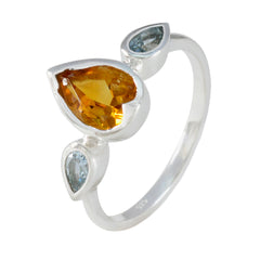 Kennedy multicolor trilogy gemstone ring with one large orange and two smaller blue pear-shaped stones