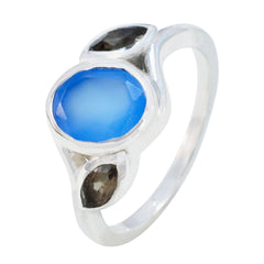 Ellie multicolor trilogy gemstone ring with blue oval center stone and two smaller dark stones on silver band