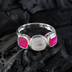 Putri multicolor trilogy ring with silver band and three colorful gemstones on dark textured background