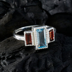 Elena silver ring with emerald cut aquamarine center and two rectangular garnet side stones multicolor trilogy ring