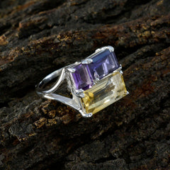 Marie multicolor trilogy ring with purple and yellow gemstones set in silver band on textured surface