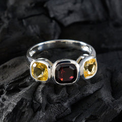 Milagros multicolor trilogy ring featuring a red center stone flanked by two yellow gemstones in silver setting