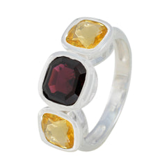 Milagros multicolor trilogy ring with one dark red and two yellow gemstones set in silver band