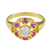 Jiwoo Navratna engagement ring with gold band, central clear gemstone, and pink stones surrounding it