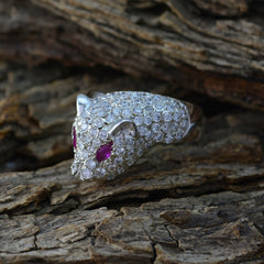 Eliza pink gemstone statement ring designed as an animal head with sparkling stones on wood