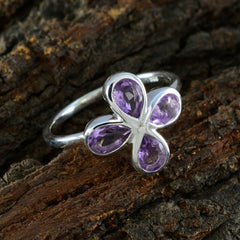 Silver Natalie ring with four pear shaped stones forming a flower on wood backdrop purple floral gemstone ring