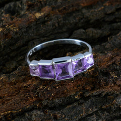Priya silver ring featuring five square-cut purple gemstones purple gemstone ring on dark textured background