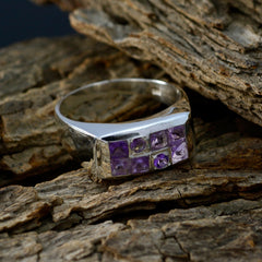 Pauline silver purple gemstone statement ring with six square amethyst stones in modern rectangular setting on wood background
