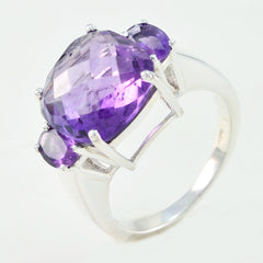 Layla purple gemstone trilogy ring with a large faceted center stone and two smaller side stones set in silver