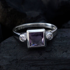 Scarlett silver ring featuring a purple gemstone trilogy ring design with a square purple stone and two clear side stones