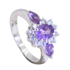 Lily purple gemstone trilogy ring with a central oval purple stone and two marquise side stones surrounded by clear crystals