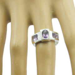 Ella purple gemstone trilogy ring with three purple stones set in silver band on hand