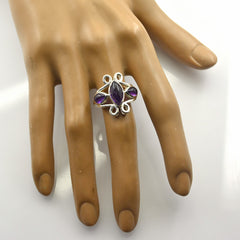 Siti purple gemstone trilogy ring with silver setting on display hand