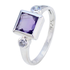 Scarlett silver ring featuring a purple gemstone trilogy ring design with square purple stone and two clear stones