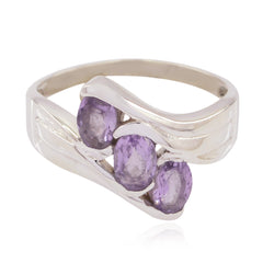 Bruna elegant purple gemstone trilogy ring with three oval purple stones set in a silver band