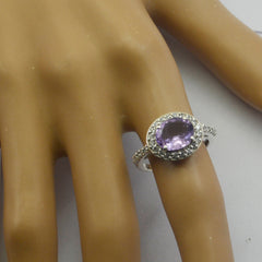 Yasmin purple halo ring with oval amethyst center and clear stone halo on silver band displayed on mannequin hand