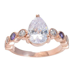 Stella purple navratna ring with pear-shaped clear center stone and alternating purple and white gemstones