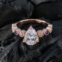 Stella purple navratna ring with a large pear-shaped center stone and alternating purple and clear gemstones