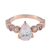 Stella purple navratna ring with pear-shaped center stone and alternating purple and clear gemstones
