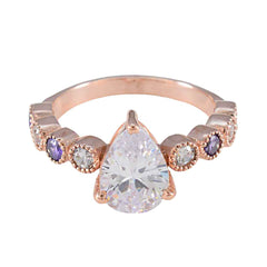 Stella purple navratna ring with pear-shaped center stone and alternating purple and clear gemstones
