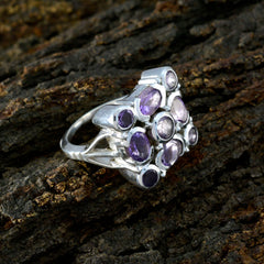Nia silver purple navratna ring with multiple oval purple gemstones on textured dark background