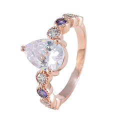 Stella purple navratna ring with pear-shaped clear center stone and small purple and white stones on rose gold band