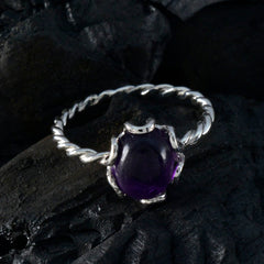 Yan purple solitaire ring with twisted silver band and deep purple gemstone on dark background