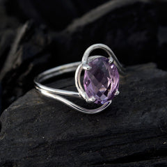 Ying purple solitaire ring with oval faceted amethyst and twisted sterling silver band on dark stone