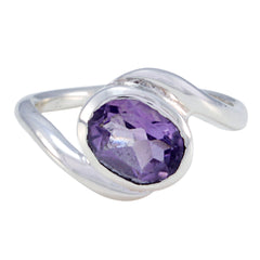 Angel purple solitaire ring with oval faceted gemstone set in a sleek silver band