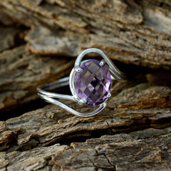 Ying purple solitaire ring with oval faceted amethyst set in sterling silver twisted band on rustic wood