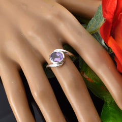 Angel purple solitaire ring with round gemstone set in silver band on mannequin hand