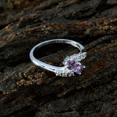 Nari silver purple toi et moi ring with two purple gemstones and small clear stones on textured dark background