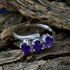Victoria purple trilogy gemstone ring sterling silver band with three faceted amethyst stones on rustic wood