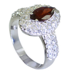 Meera red abstract halo ring with a marquise red gemstone and sparkling white stones on silver band