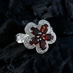 Isla red floral gemstone ring with deep red stones and silver detailing in flower shape