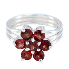 Natalie red floral gemstone ring with silver band featuring six round red stones in flower design