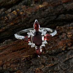 Carolina red gemstone fashion ring with oval center garnet pear accents and diamond halo on silver band