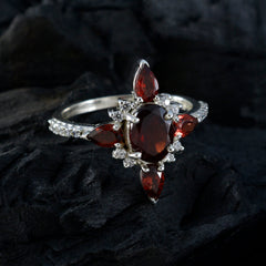 Carolina silver ring with oval center and pear side stones and pave accents red gemstone fashion ring