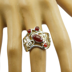 Isadora red gemstone filigree ring with intricate silver detailing on hand model