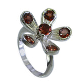 Sophia red gemstone flower ring with silver band and deep red stones in floral design