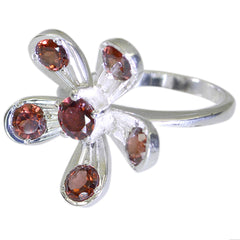 Sophia red gemstone flower ring with silver band and five red gemstones arranged like flower petals